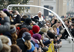 Pope Francis waves as he arrives to lead the general audience in Saint Peter's Square at the Vatican